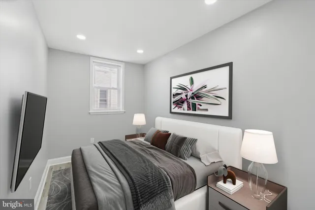 a bedroom with a bed and a flat screen tv