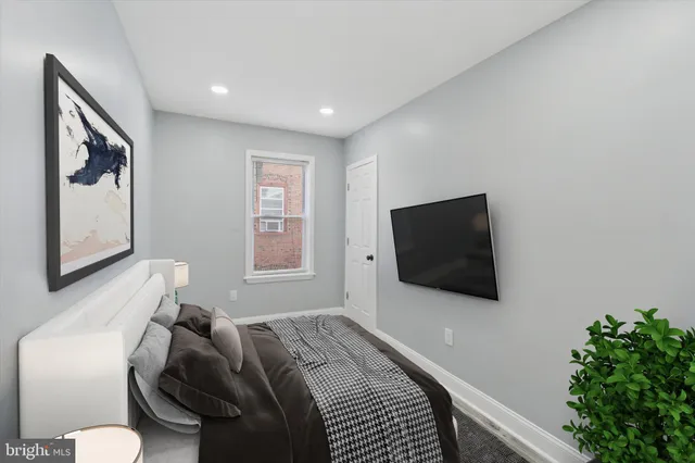 a bedroom with a bed and a flat screen tv