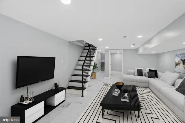 a living room with furniture and a flat screen tv