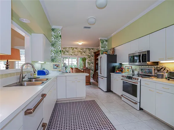 a kitchen with a sink cabinets and stainless steel appliances