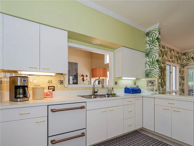 a kitchen with white cabinets and white appliances