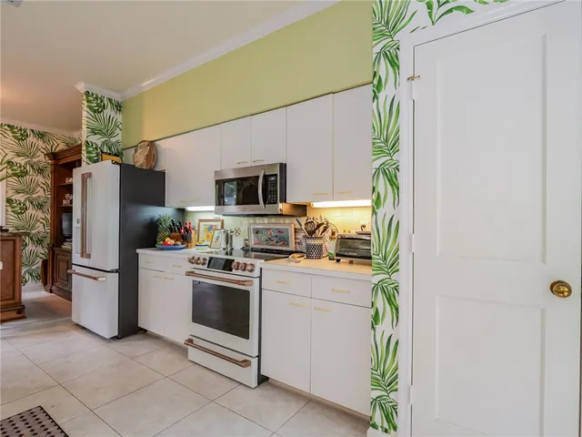 a kitchen with a sink stainless steel appliances and cabinets