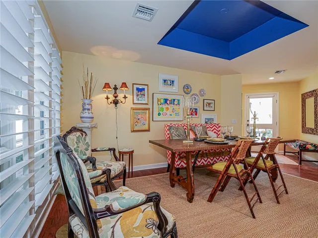 a view of a dining room with furniture and a chandelier