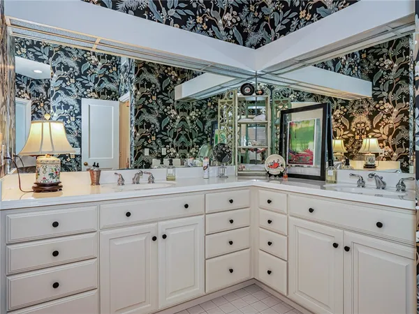 a bathroom with a double vanity sink mirror and