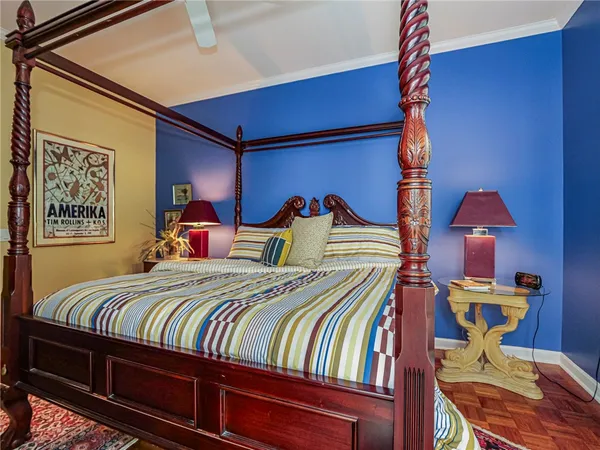 a bedroom with two beds and a lamp on the dresser