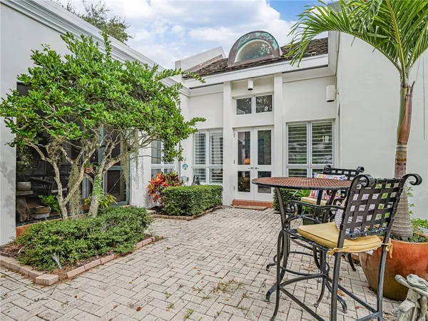 a view of a patio with table and chairs and potted plants
