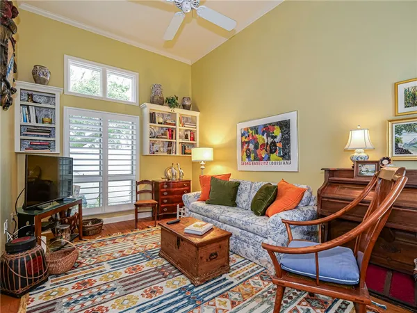a living room with furniture a flat screen tv and a window