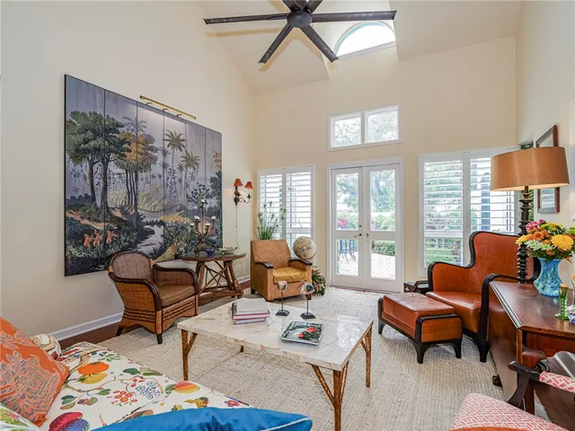 a living room with furniture and floor to ceiling windows
