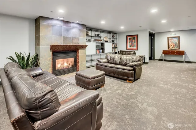 a kitchen with stainless steel appliances granite countertop table chairs and a refrigerator
