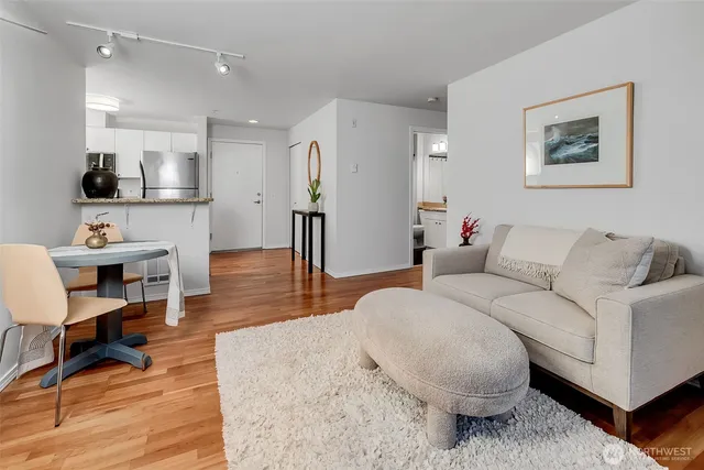 a living room with furniture and a wooden floor