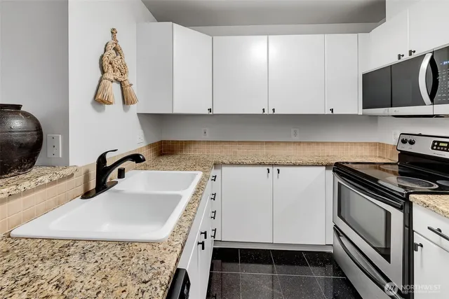 a kitchen with a sink and a stove top oven