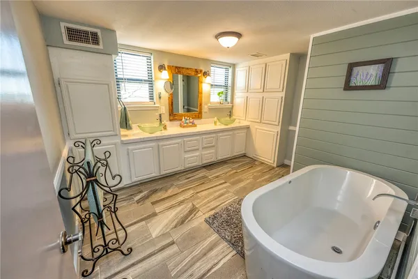 a spacious bathroom with a bathtub and sink