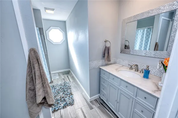 a view of bathroom with mirror and sink
