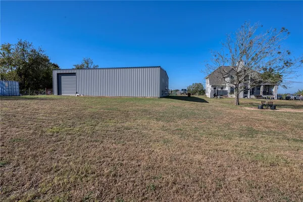 a view of a yard with wooden fence
