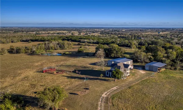 an aerial view of a house with a yard