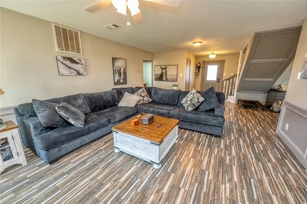 a living room with furniture and wooden floor
