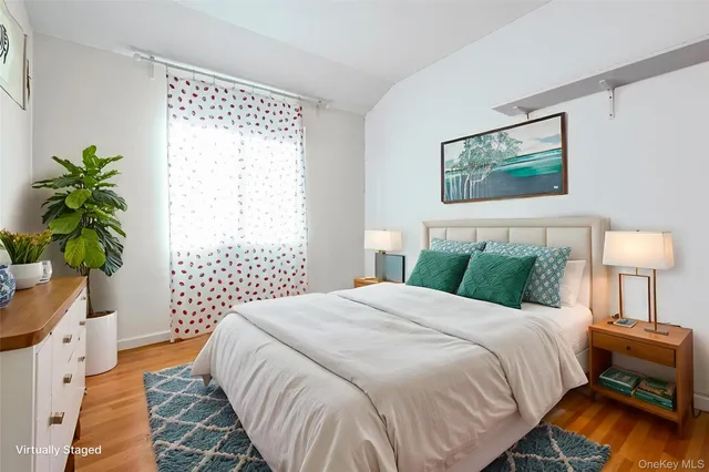 a bedroom with a bed and a lamp