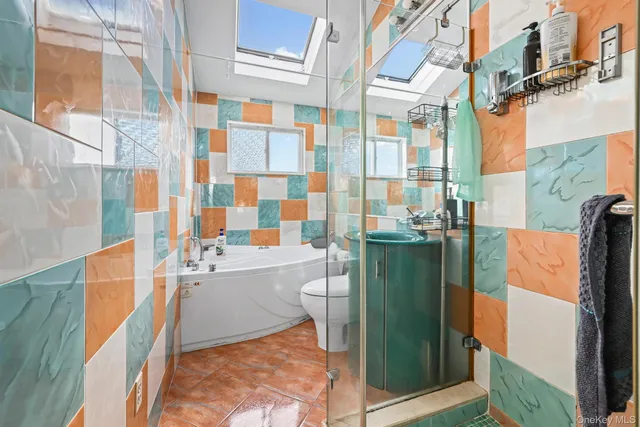 a bathroom with a sink a toilet and shower