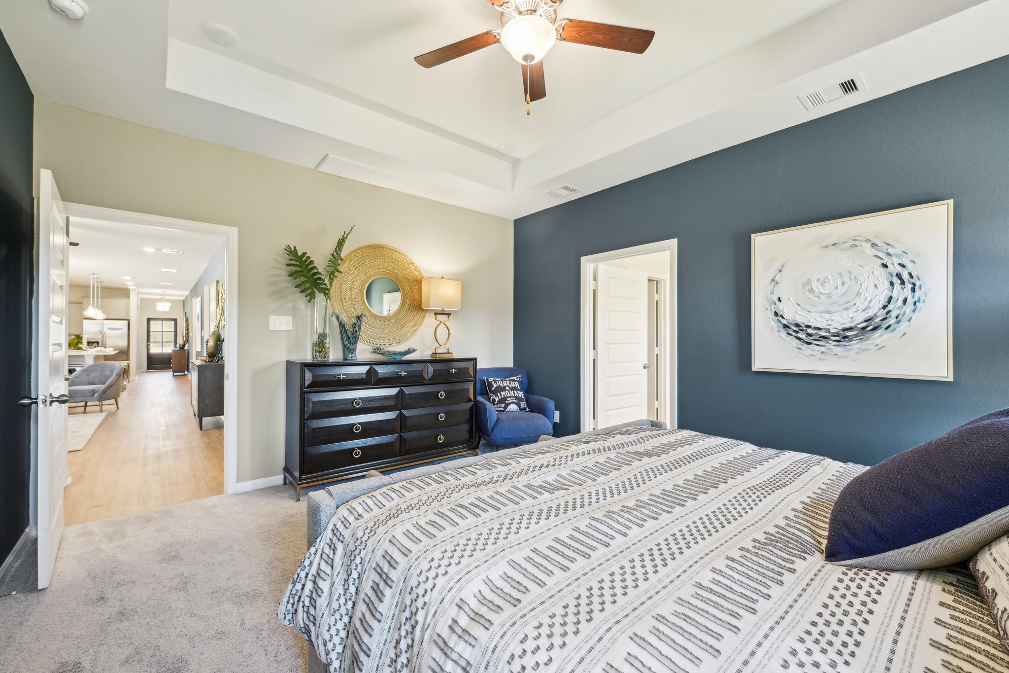 9706 Enclave Ridge Road Willis, TX 77318 - Photo 13 of 19 a bedroom with a bed and a chandelier