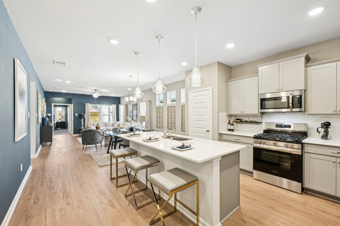 9706 Enclave Ridge Road Willis, TX 77318 - Photo 2 of 19 Oakshire II- Kitchen & Family. Sample image for illustration; upgrades, options, and colors may vary.