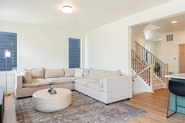 a living room with furniture and a rug