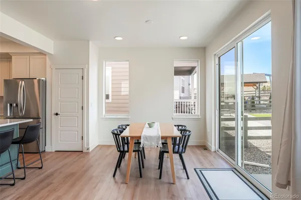a view of a dining room with furniture and a window
