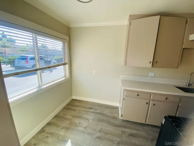 a view of a kitchen with a sink wooden floor and a window