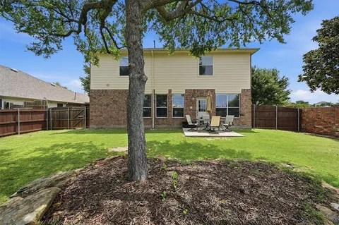 a view of a backyard with furniture and a garden