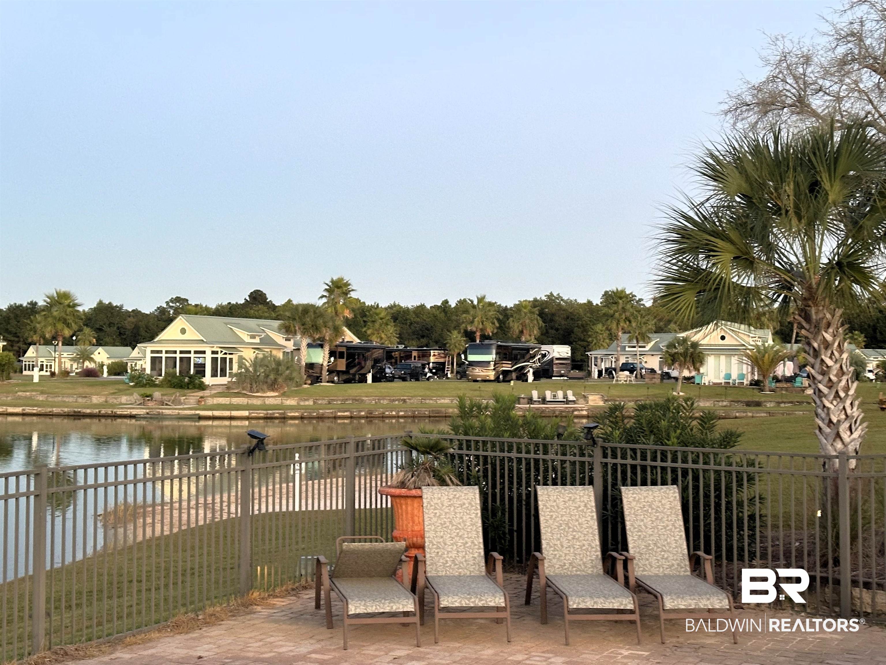 11869 Gateway Drive Elberta, AL 36530 - Photo 37 of 78 View of home's community with fence, a water view, and a pool patio