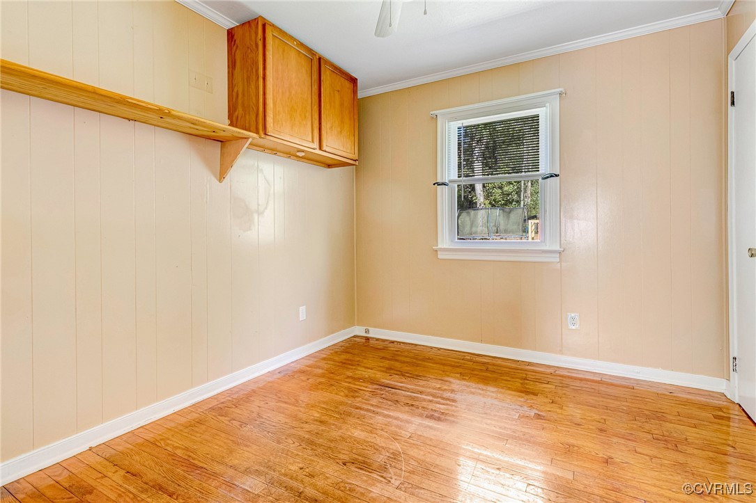 8929 Old Elam Cemetary Road Charles City, VA 23030 - Photo 11 of 20 Spare room with light wood-type flooring, crown mo