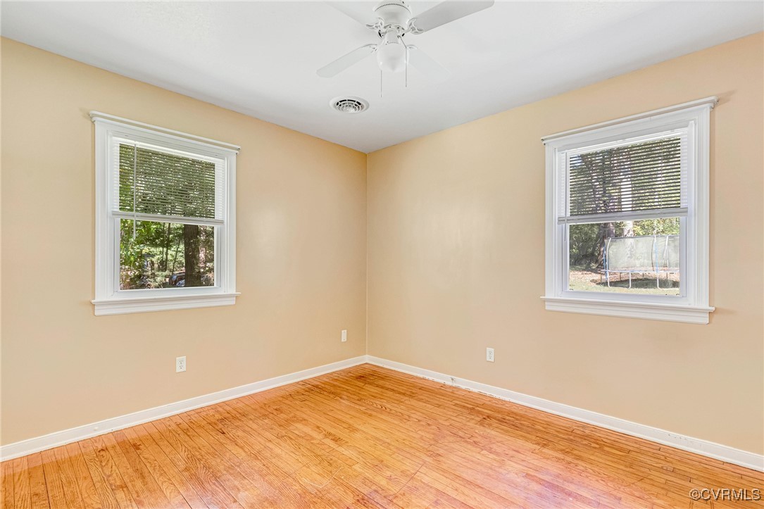 8929 Old Elam Cemetary Road Charles City, VA 23030 - Photo 12 of 20 Unfurnished room with ceiling fan and light hardwo