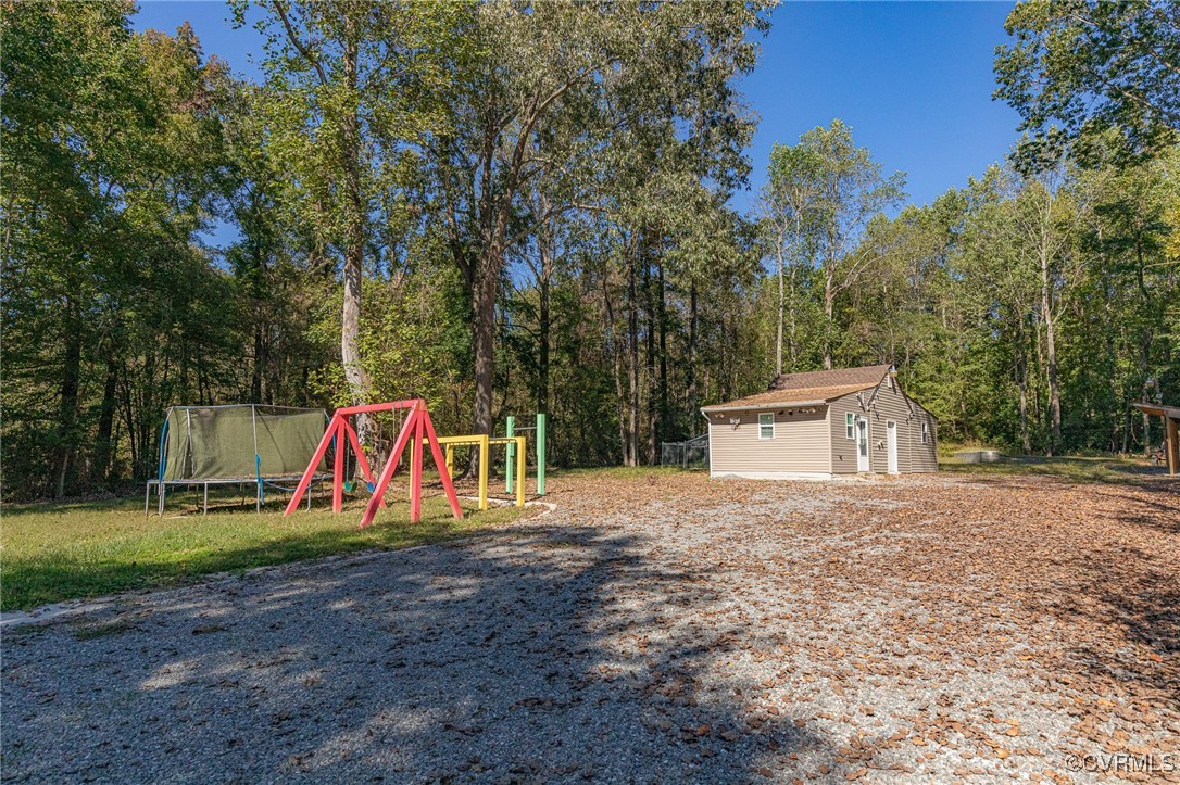 8929 Old Elam Cemetary Road Charles City, VA 23030 - Photo 17 of 20 View of yard featuring an outbuilding, a playgroun