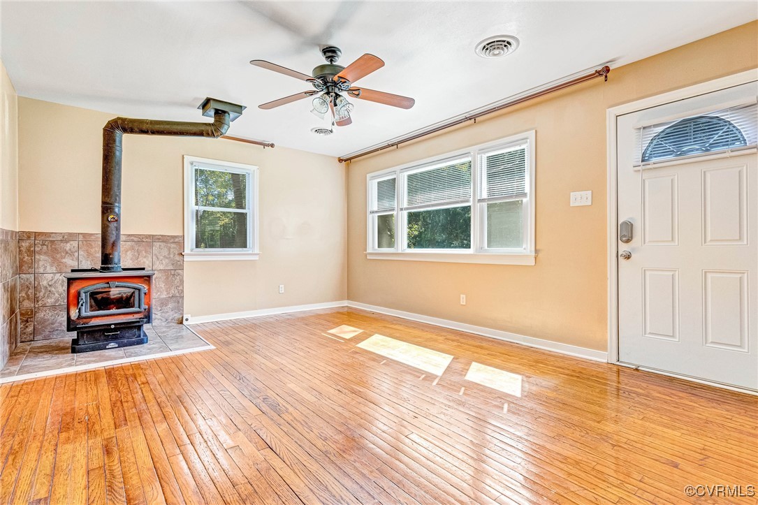 8929 Old Elam Cemetary Road Charles City, VA 23030 - Photo 3 of 20 Unfurnished living room featuring a wood stove, li