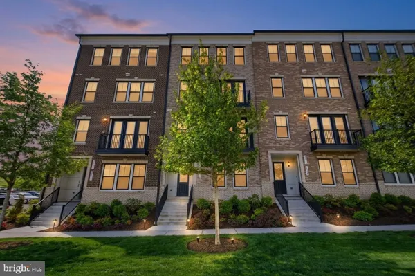 front view of a brick building next to a yard
