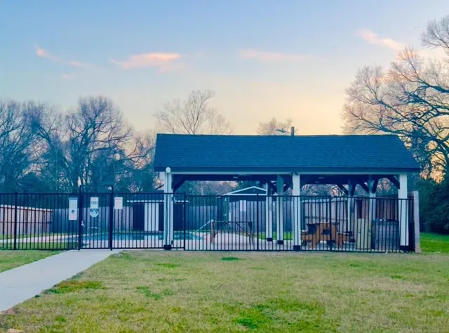a view of a house with swimming pool and a yard