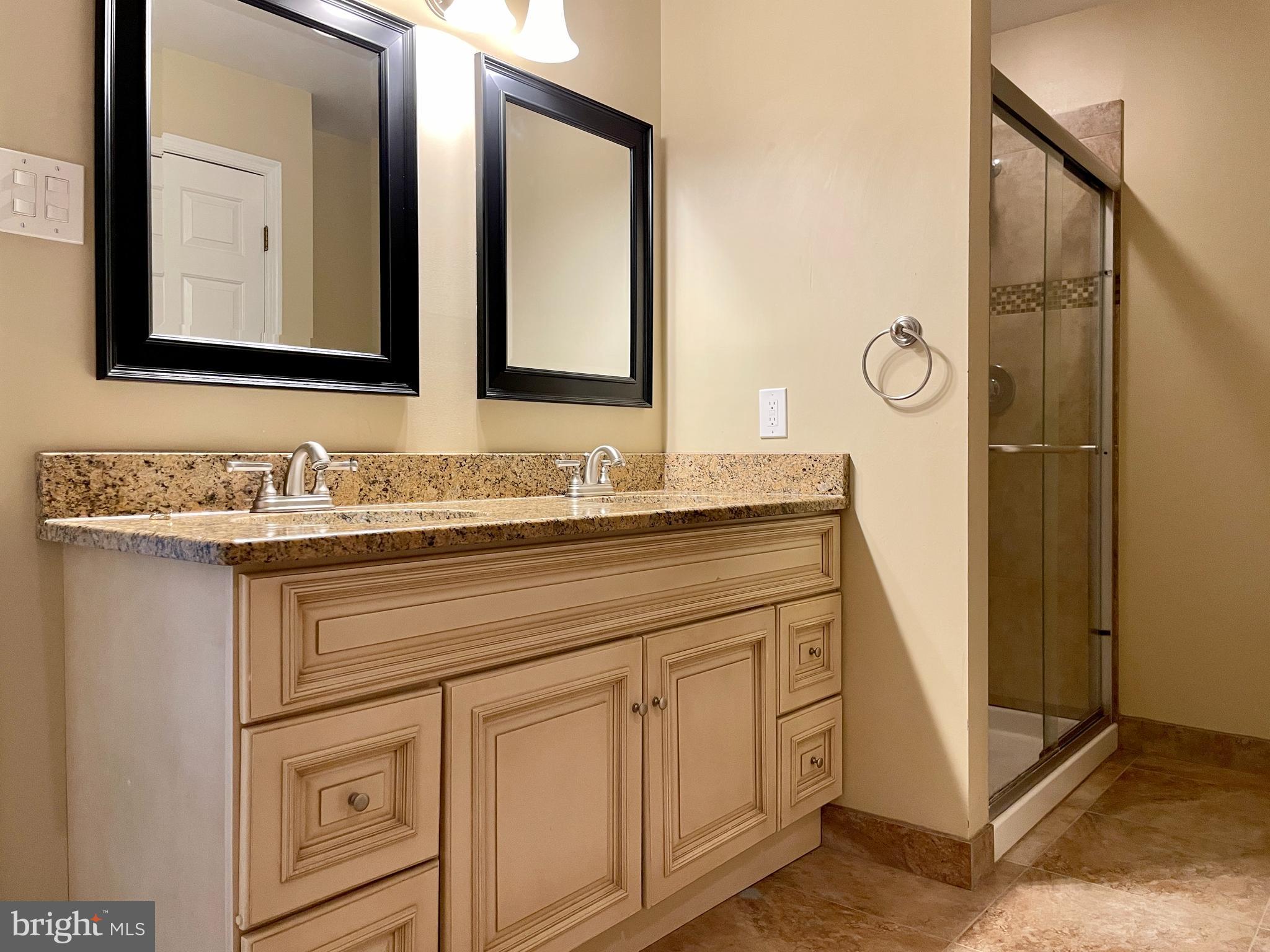 503 Brighton Road Devon, PA 19333 - Photo 12 of 20 a bathroom with a granite countertop sink and a mirror