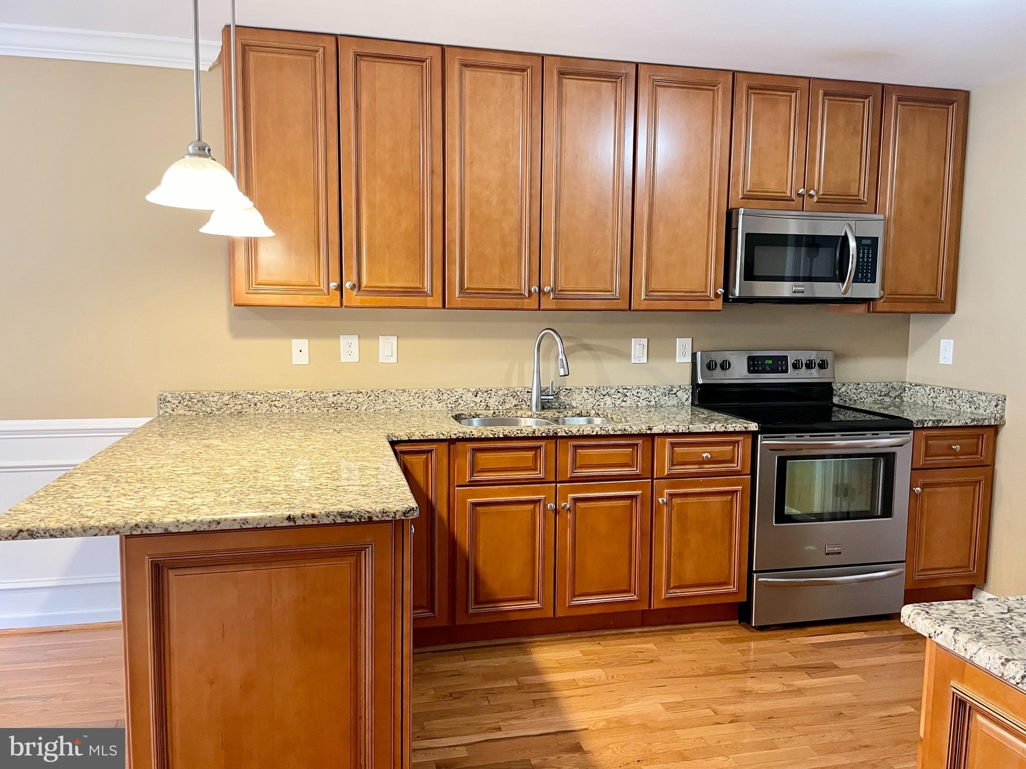 503 Brighton Road Devon, PA 19333 - Photo 3 of 20 a kitchen with stainless steel appliances granite countertop a stove a sink and a microwave