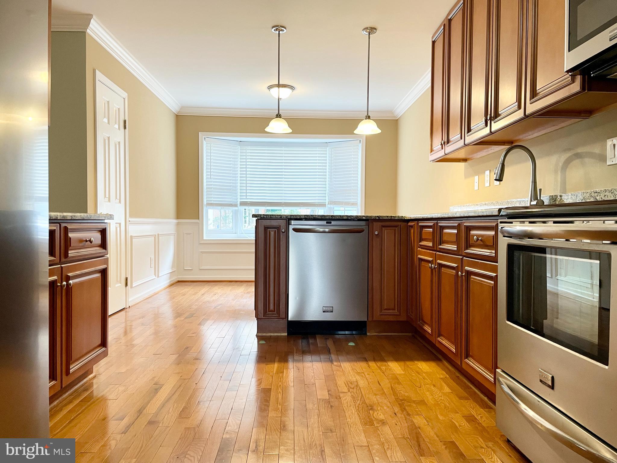 503 Brighton Road Devon, PA 19333 - Photo 4 of 20 a kitchen with stainless steel appliances granite countertop a stove a sink and a refrigerator