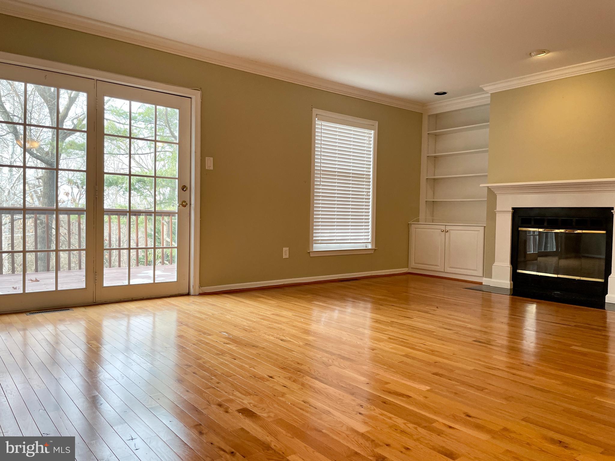 503 Brighton Road Devon, PA 19333 - Photo 7 of 20 wooden floor fireplace and windows in an empty room
