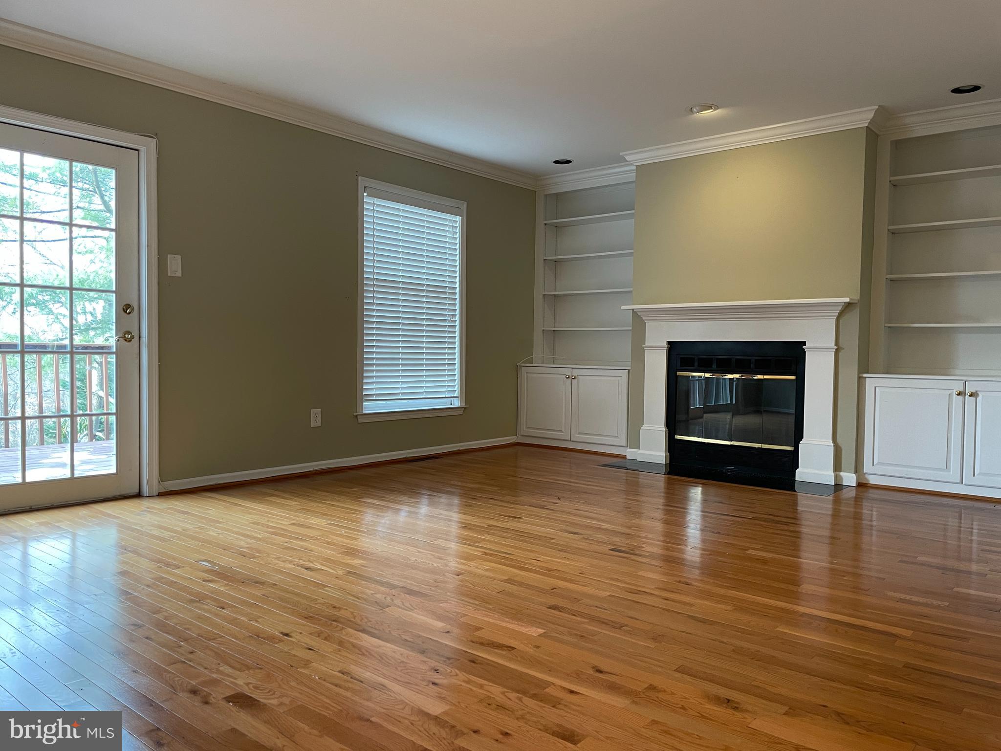 503 Brighton Road Devon, PA 19333 - Photo 8 of 20 an empty room with wooden floor fireplace and windows