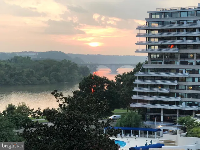 a bedroom with a bed and a potted plant