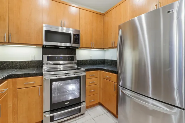 a view of a kitchen with wooden floor and a sink