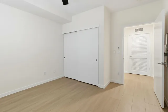 an empty room with a gallery and wooden floor