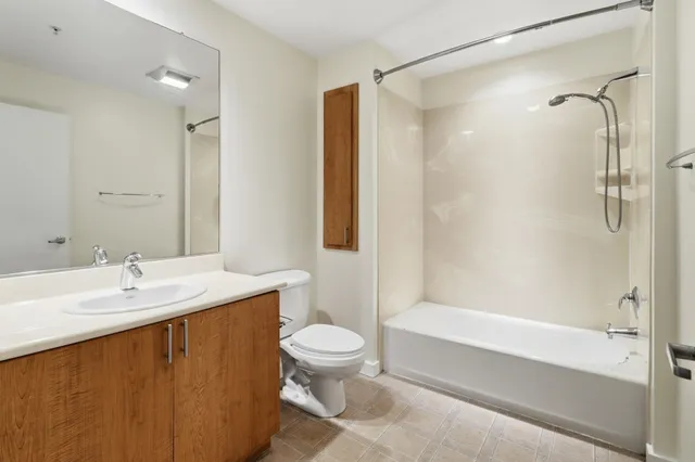 a spacious bathroom with a shower sink and mirror
