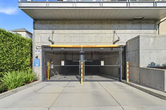 a view of a cars park in front of a building