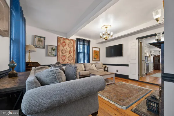a living room with furniture and a chandelier