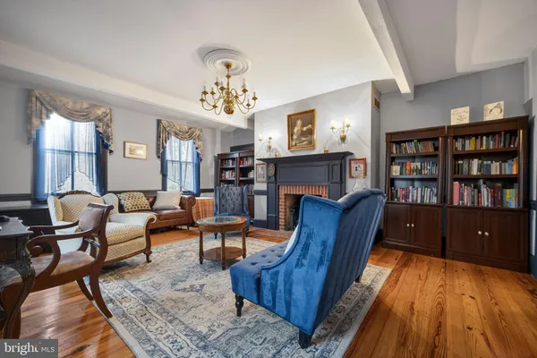 a living room with furniture and a chandelier