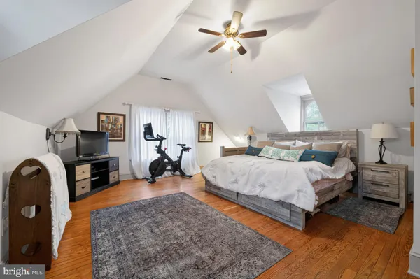 a bedroom with a bed and a television