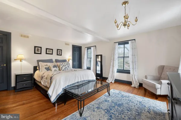 a view of a room with wooden floor and a ceiling fan