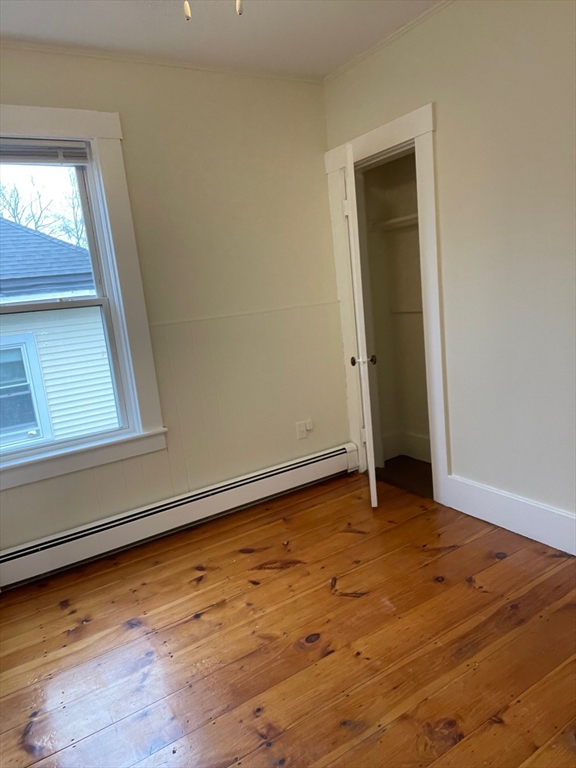 7 Spruce Street, Unit 2 Clinton, MA 01510 - Photo 5 of 8 a view of an empty room with wooden floor and a window